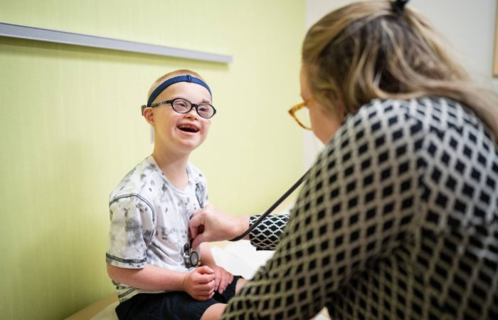 Gillette patient Peter Collins smiles during an examination in clinic by Gillette provider Heidi Davis.