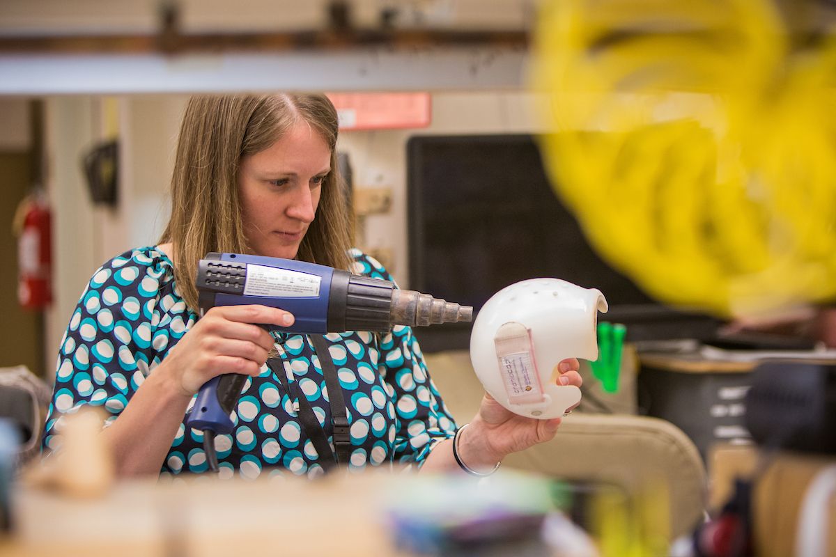 A Gillette orthotist works on shaping a CranioCap.