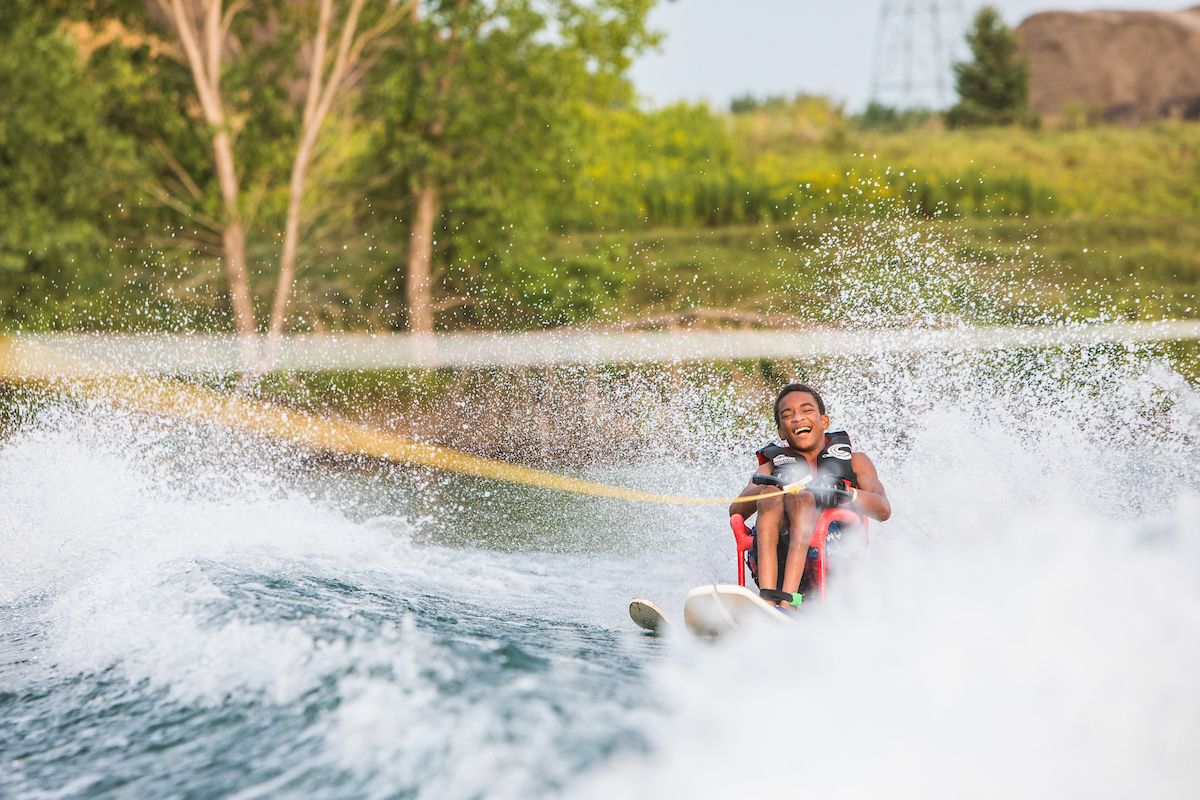 A child participating in adaptive water skiing.