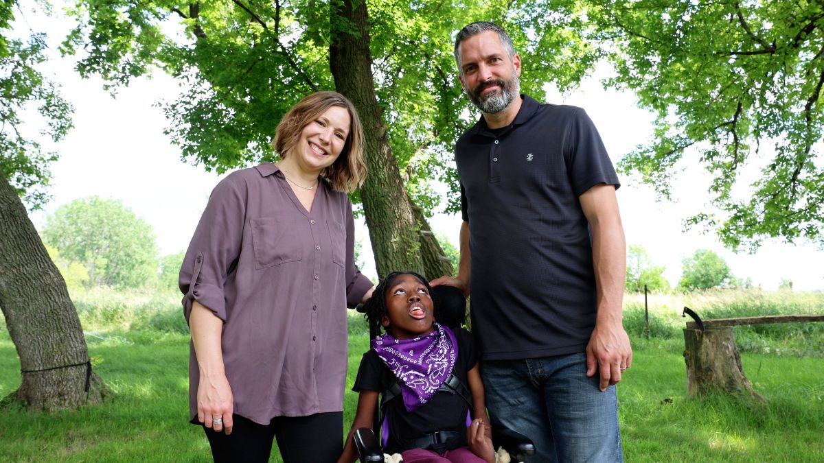 Jenny, Angelina and Jamie Groen smile while spending time in their backyard.