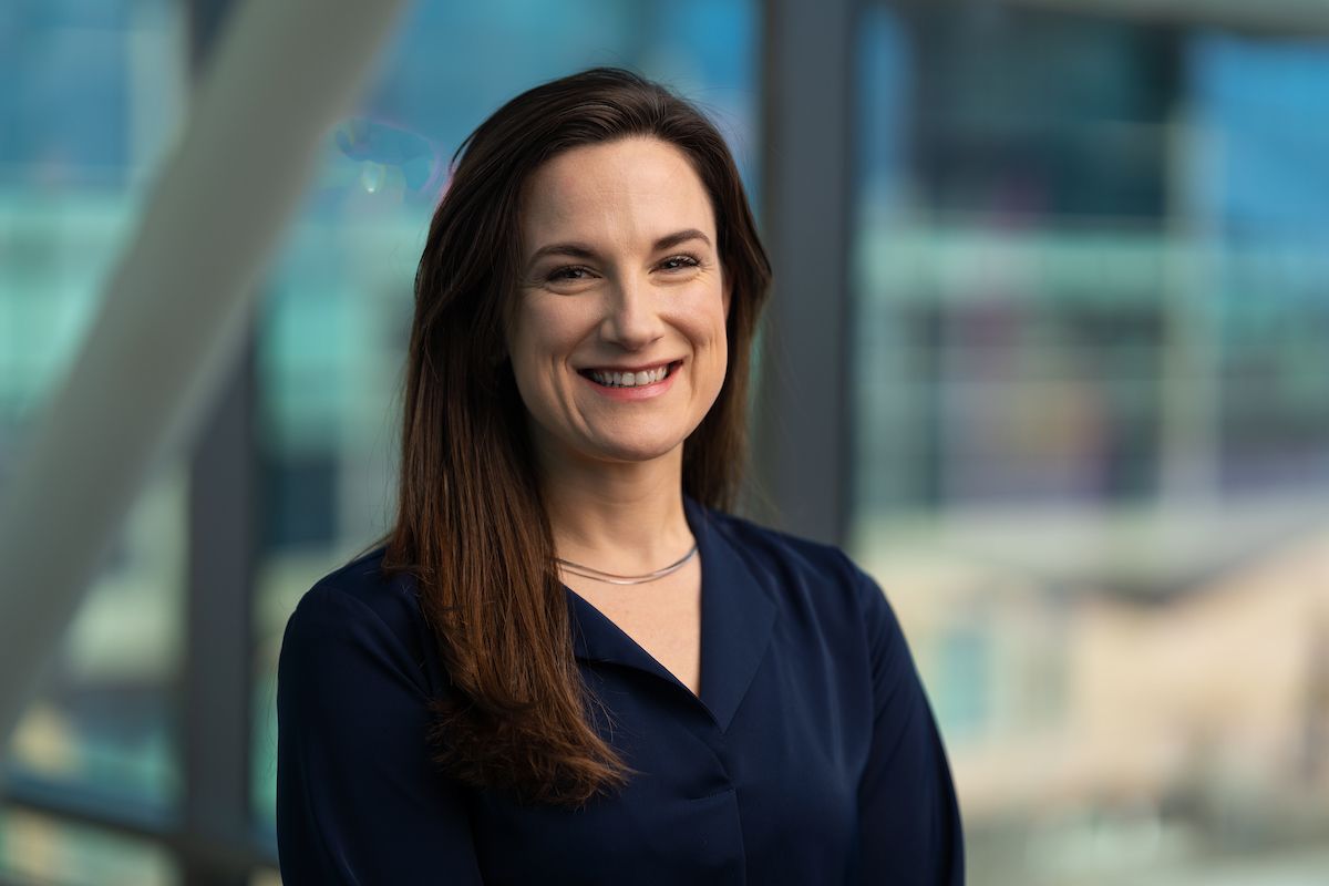 Gillette senior clinical scientist, Chantel Burkitt, PhD, standing in the hospital skyway.