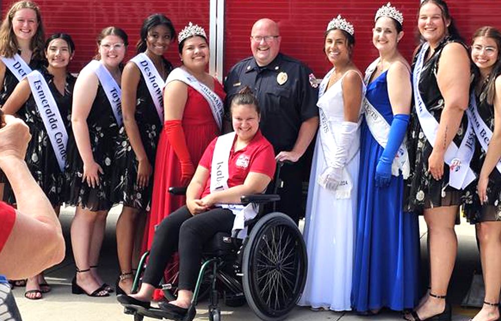 Isabelle sits in her wheelchair as she and other Miss Willmar contestants visit a local fire station.