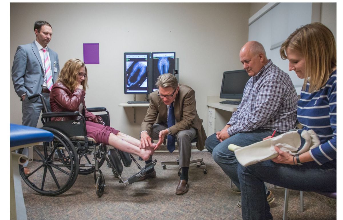 Kate Ketelhohn and her parents, Charlie and Julie, meet with Gillette pediatric surgeon, Mark Dahl, MD, in 2018.